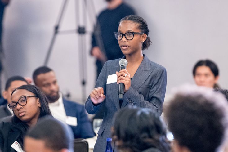 Student confidently presenting and participating in a discussion
